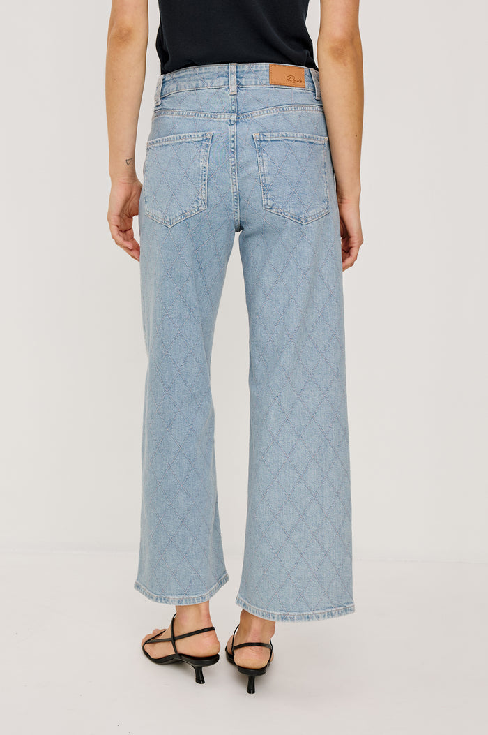 Getty Wide Leg Crop Jean in Light Stretch Denim With Wide Straight Legs, 27″ Inseam, 5-Pockets, and Front Button Fly in Quilted Stud Colorway - Lower Body Back View Featured on Model
