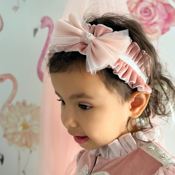 Side view of Clara Pink Velour Sash Headband showcasing plush velour texture and layered bow design.