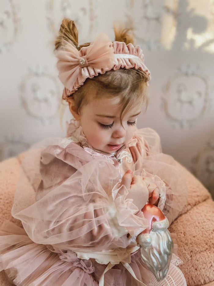 Clara Pink Velour Sash Headband styled for special occasions, featuring soft blush velour and crystal bow center.