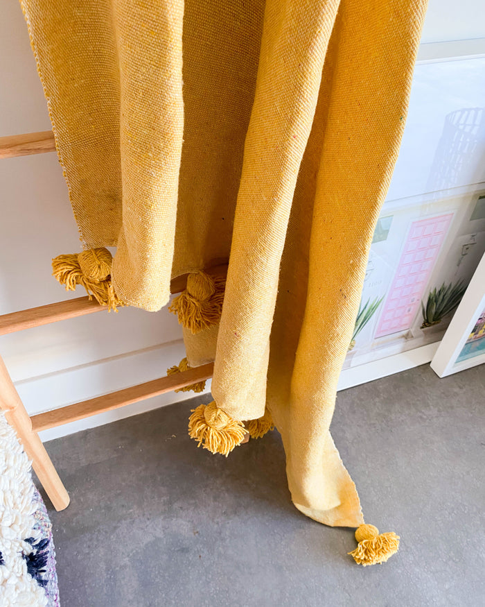 Curry Yellow handwoven Moroccan pom pom blanket