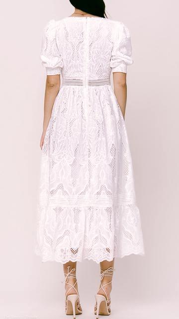 Back view of woman wearing white broderie anglaise lace midi dress with puff sleeves and square neck
