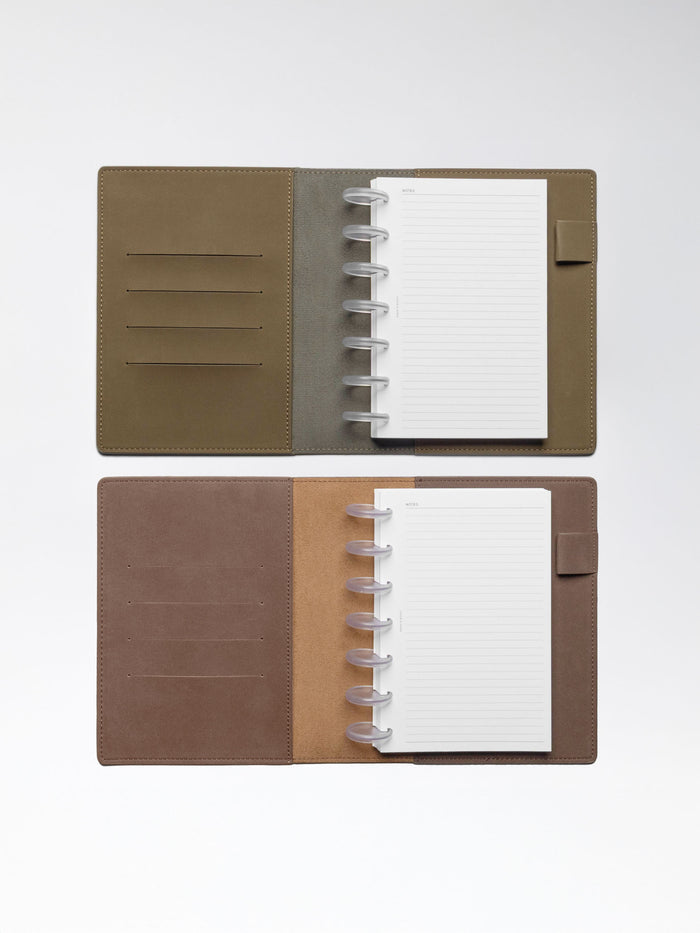 One Cipher and one Espresso folio displayed opened on a neutral background. Discbound planner systems are shown in use in each folio.