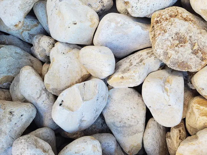 Smooth white adder boulder of rounded river rocks with gray beige speckles